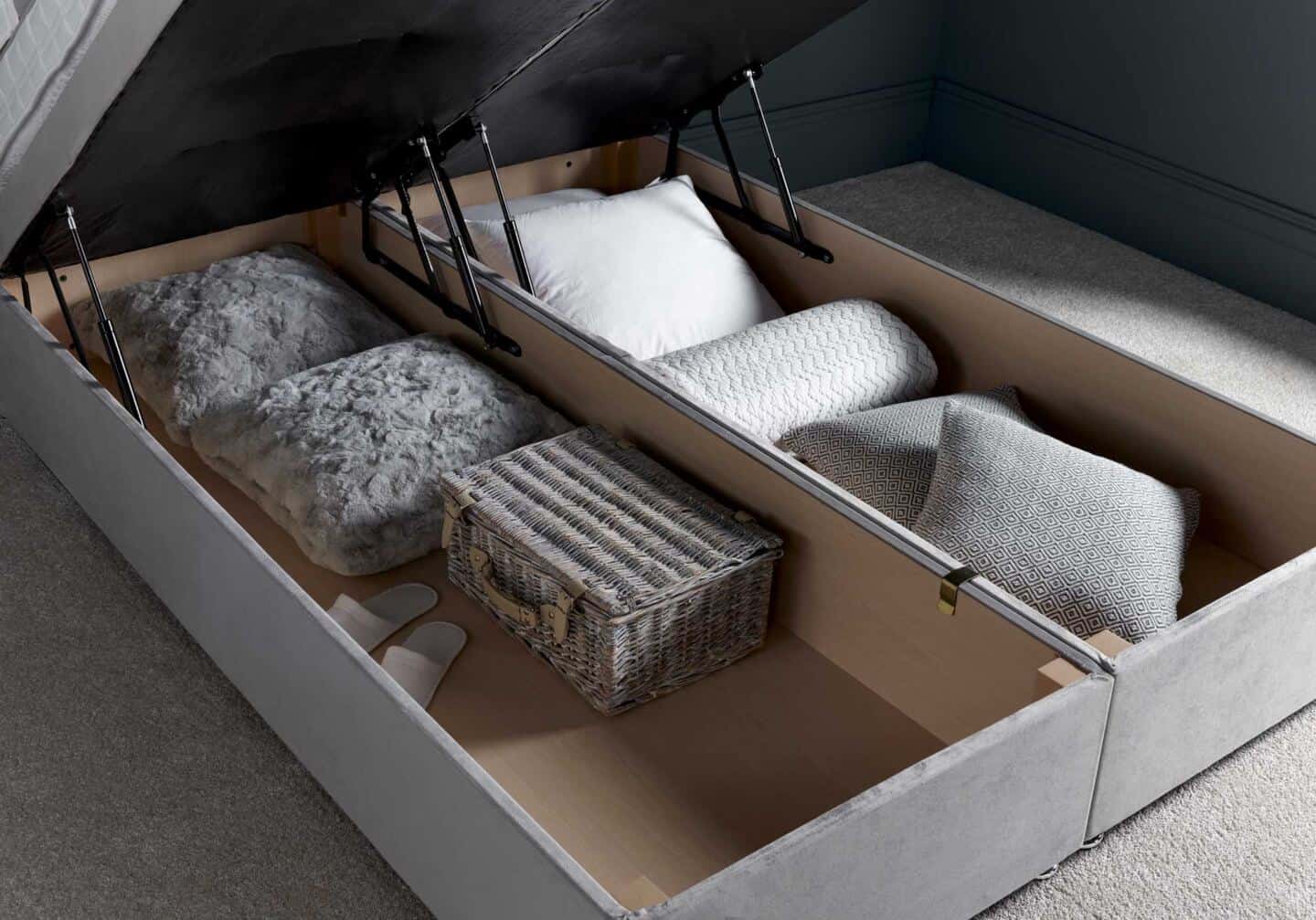 An open ottoman bed full of cushions and