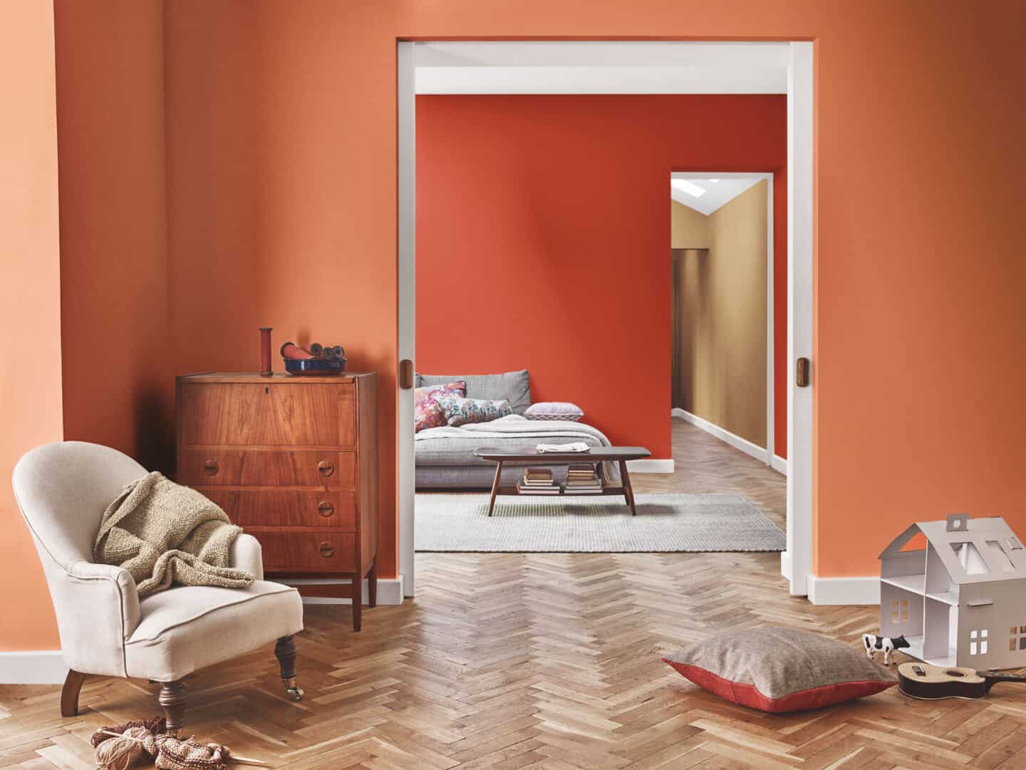 Autumnal Hues in interiors - Dulux colour of th eyear 2019 spiced honey painted on a wall that is visible through two doorways.