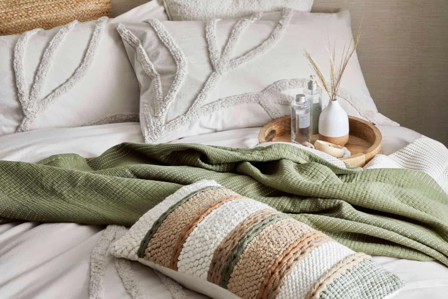 A bed made up with chunky tactile bedding