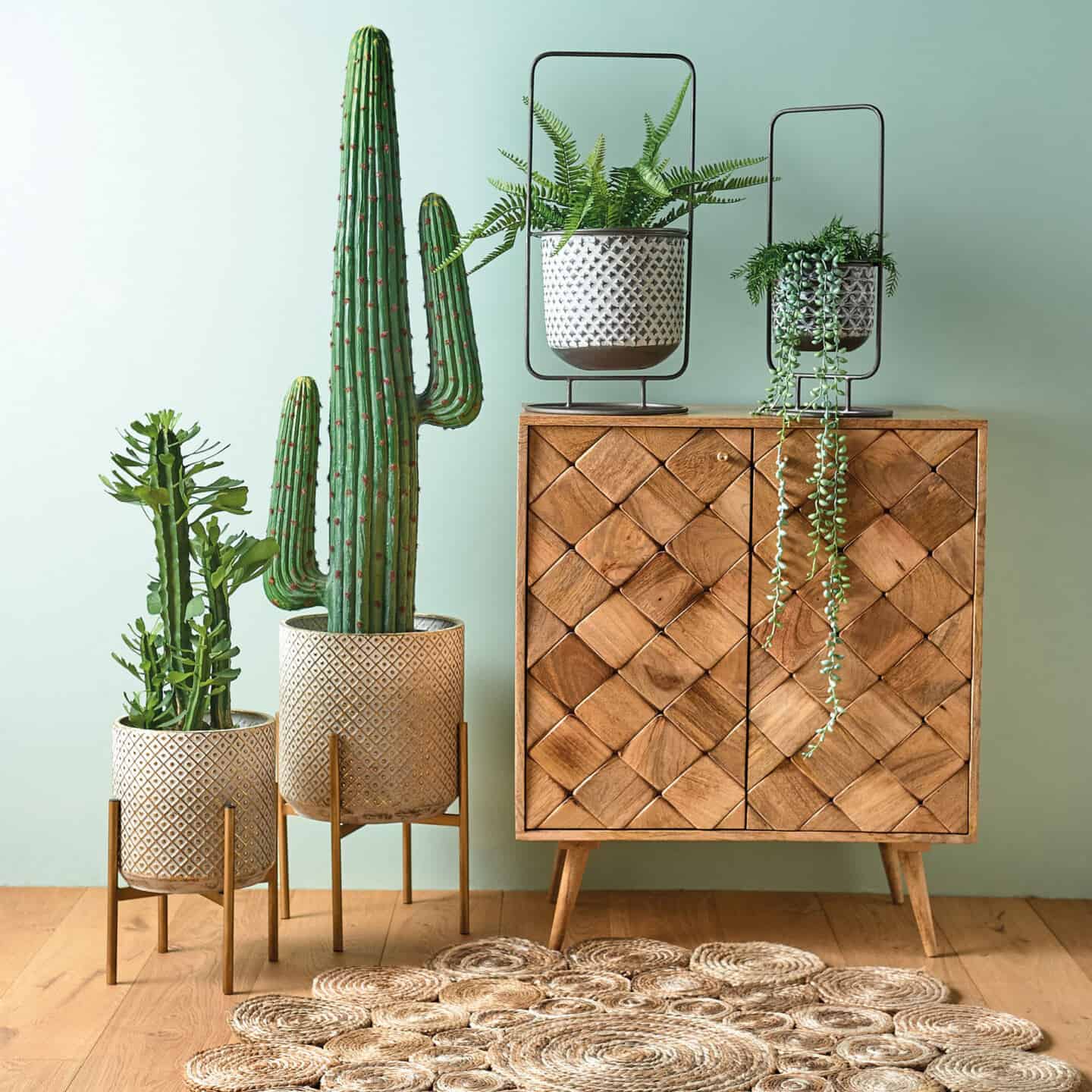 Bringing Natural Elements into the Home. Living room and featuring a wooden sideboard and plants behind a seagrass rug