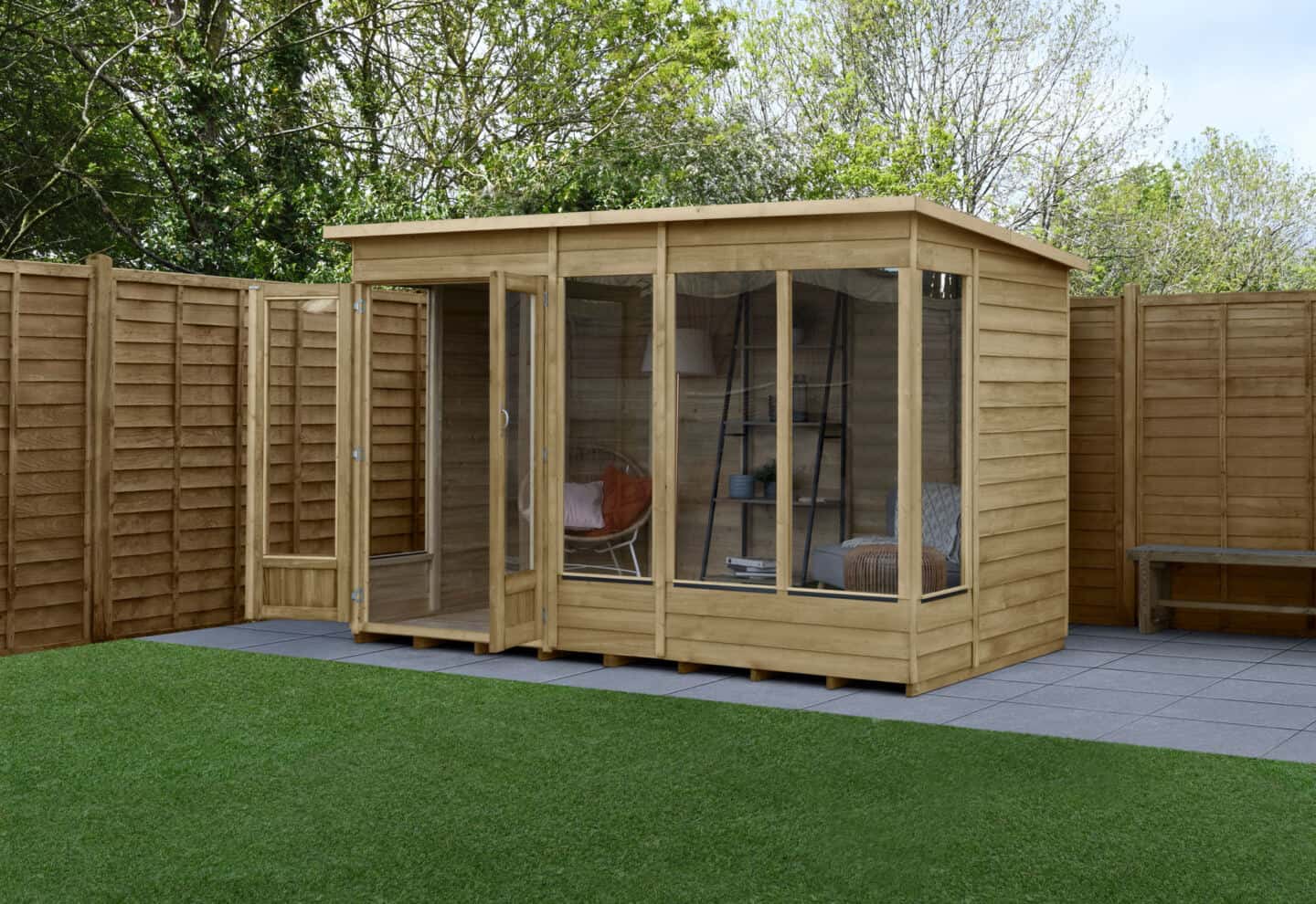 garden summer house in the corner of a garden surrounded by fencing
