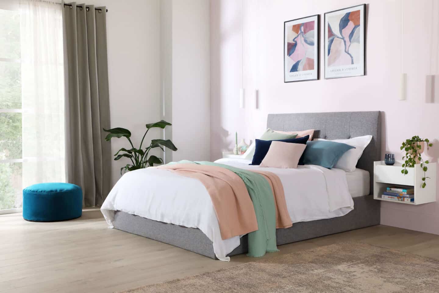 Fabric bed covered in white and pastel bedding