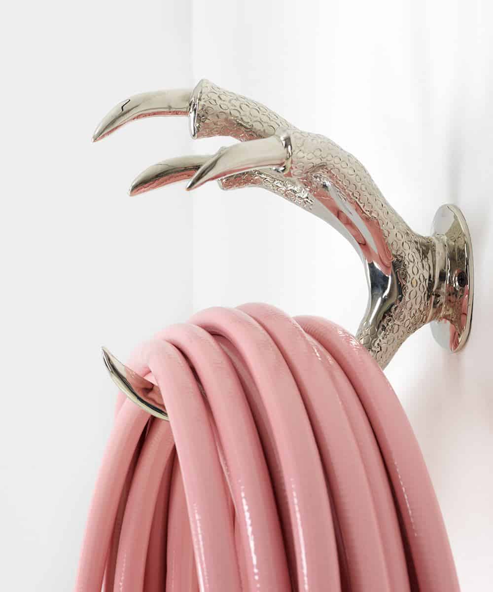Garden Glory - Stylish garden equipment - pink garden hose mounted on silver bird claw