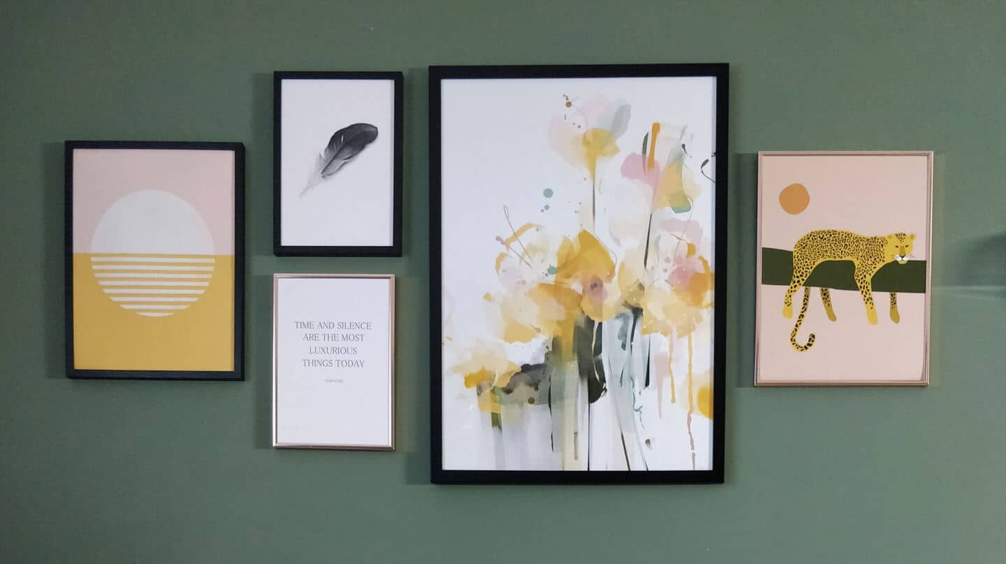 Pink & yellow artwork inspired by Travel from Greenlili hung on a moss green wall