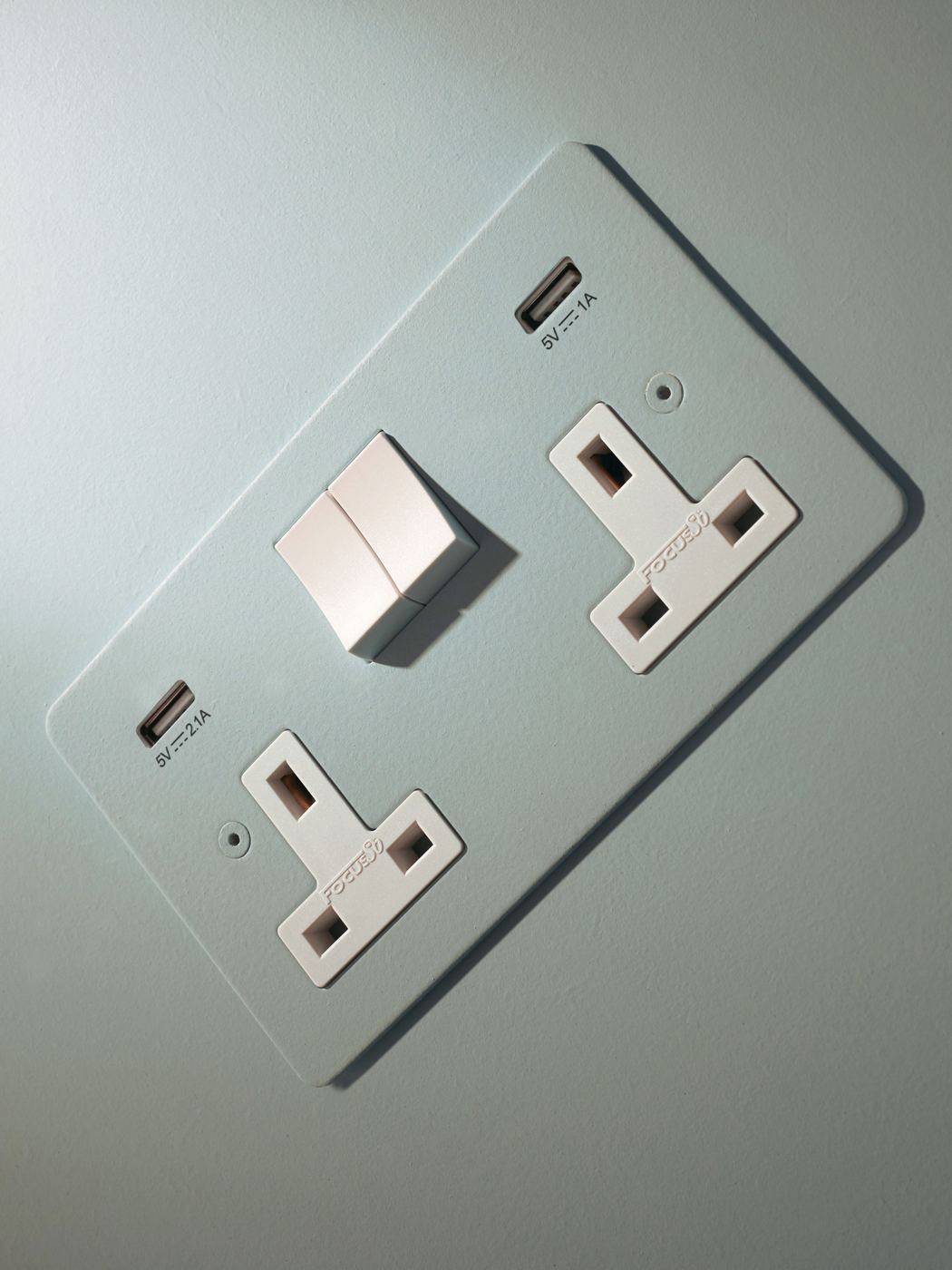 Electrical outlet in the same colour as the wall