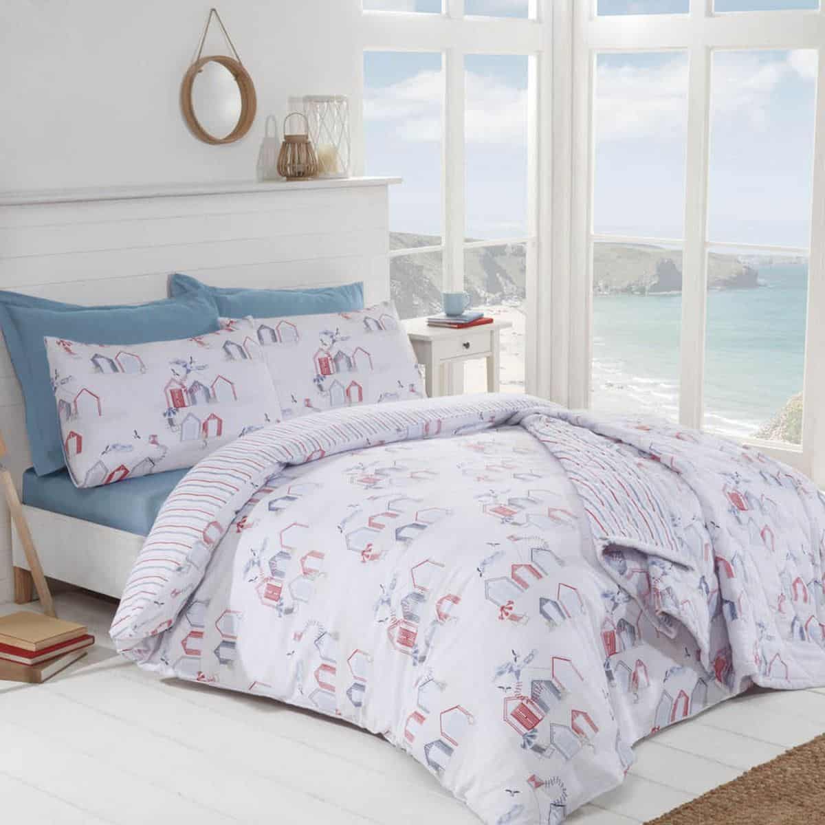 A coastal themed bedroom overlooking the sea.