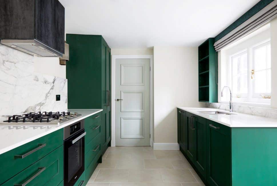 Kitchen design trends - green kitchen cabinet and marble backsplash. Design by Kia Designs