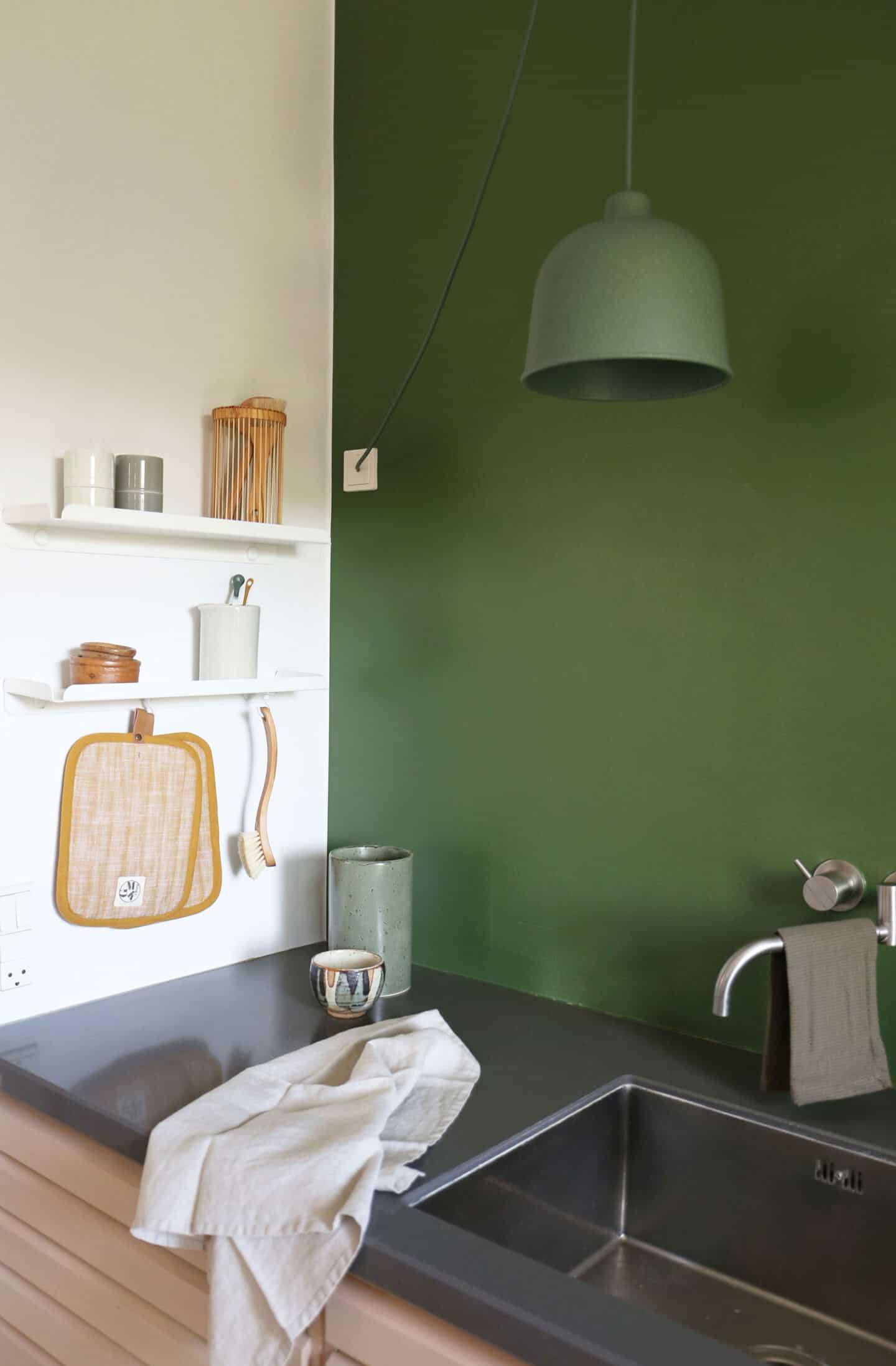 Sculptural and functional home storage solutions from Anne Linde. Small metal shelves provide minimalist storage in the kitchen.