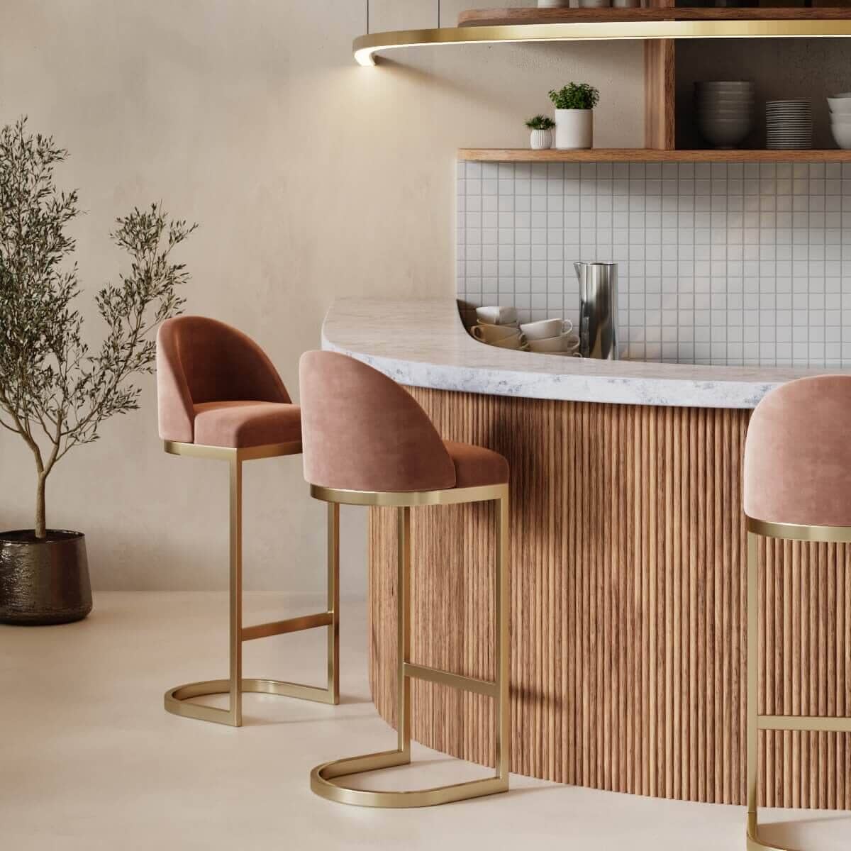 A wooden ribbed breakfast bar with marble counter top and pink velvet bar stools