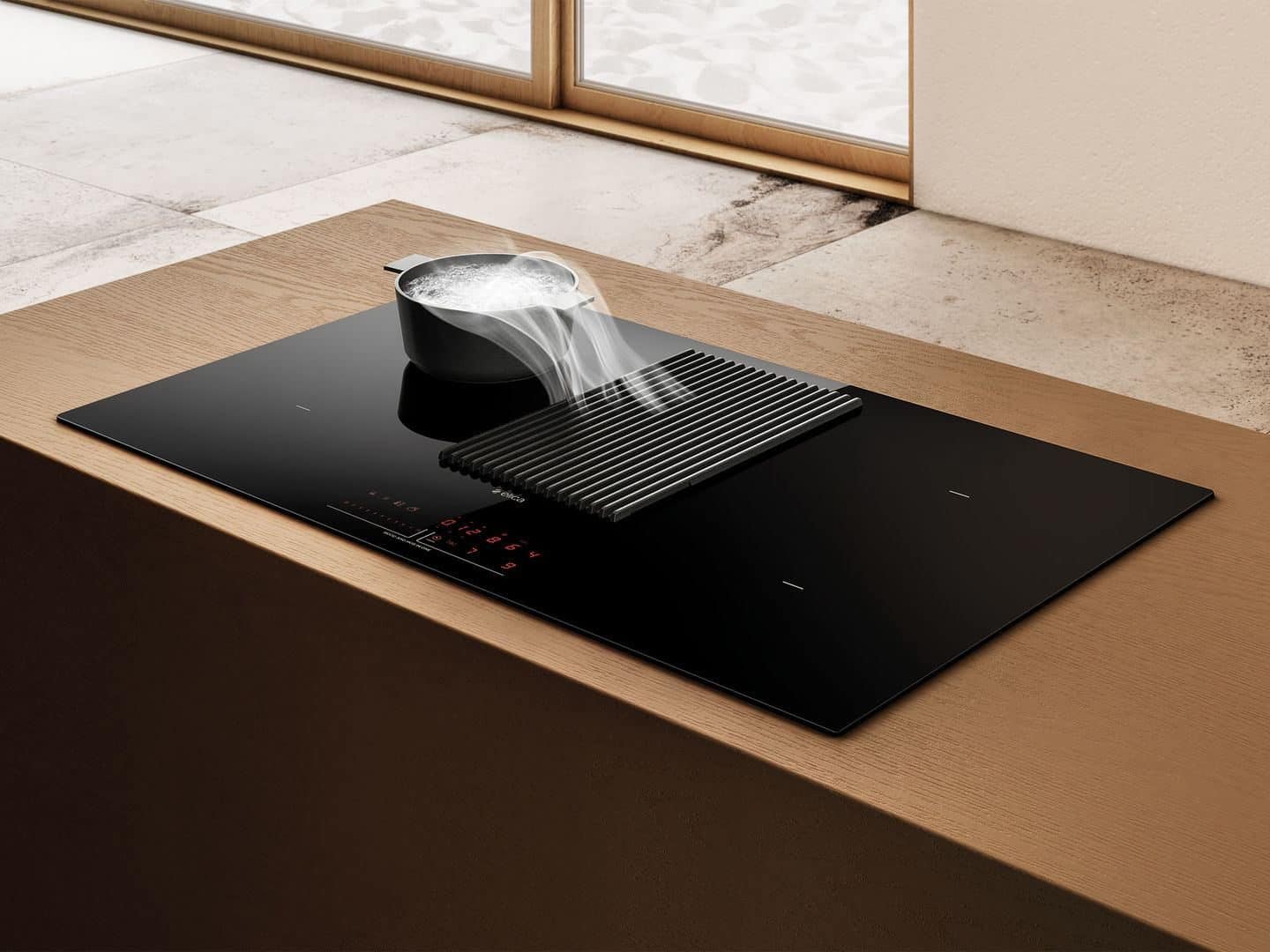 NikolaTesla Prime extractor hob from Elica shown drawing the cooking vapours down into the central grill