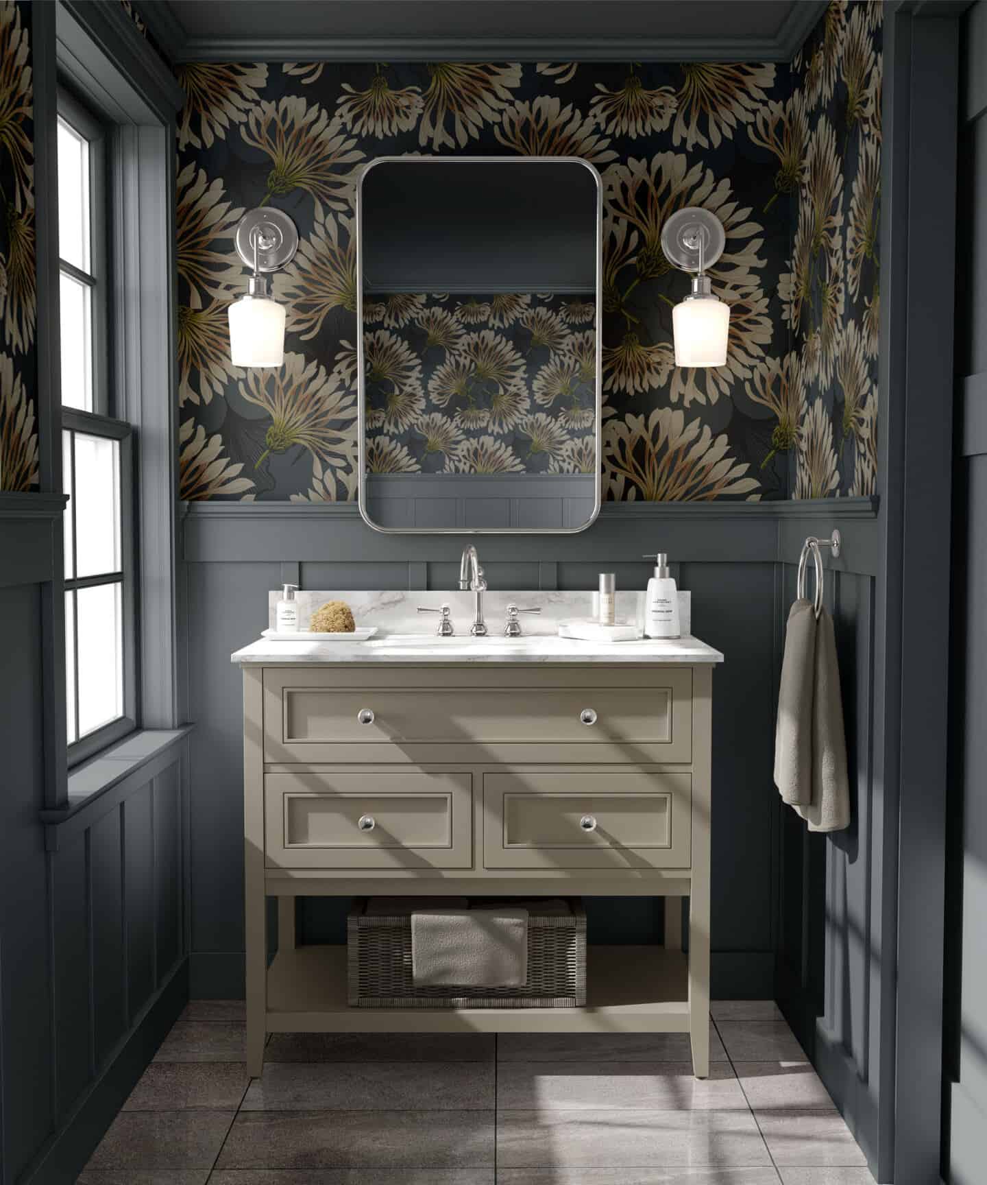 A washbasin with mirror above in a grey bathroom with wall panelling on the lower half of the wall and botanical wallpaper above.
