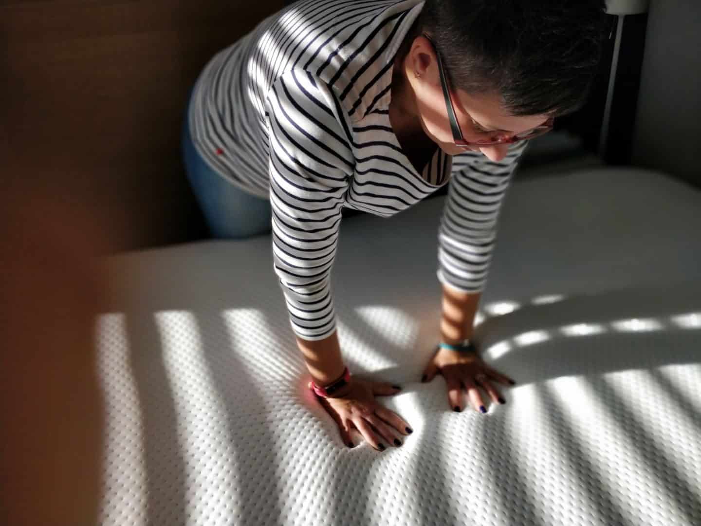 World Sleep Day 2020-5 Ways to Improve your Sleep. Lady pressing down on a memory foam mattress