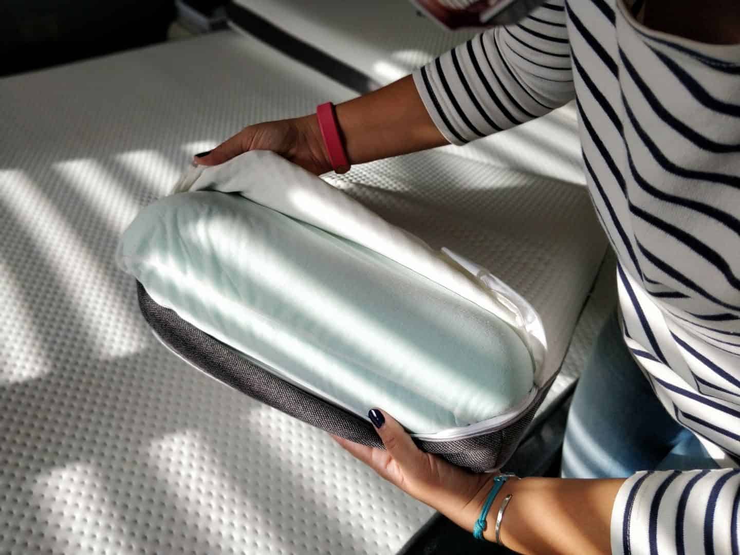 World Sleep Day 2020-5 Ways to Improve your Sleep. Lady unzipping the cover of an Ottymemory foam pillow
