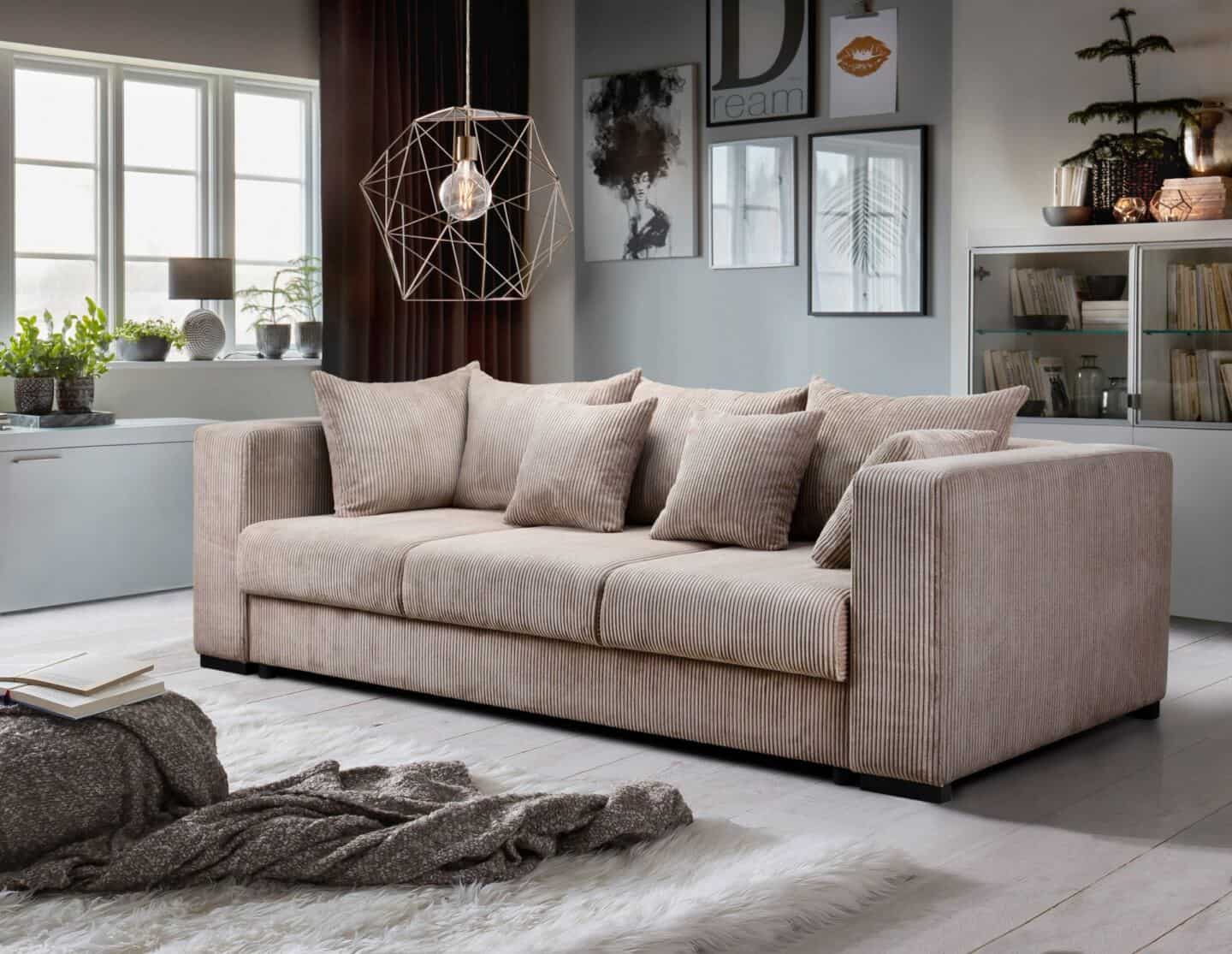 How to choose the perfect sofa for your lifestyle. Beige Corduroy sofa in middle of room with geometric light suspended above