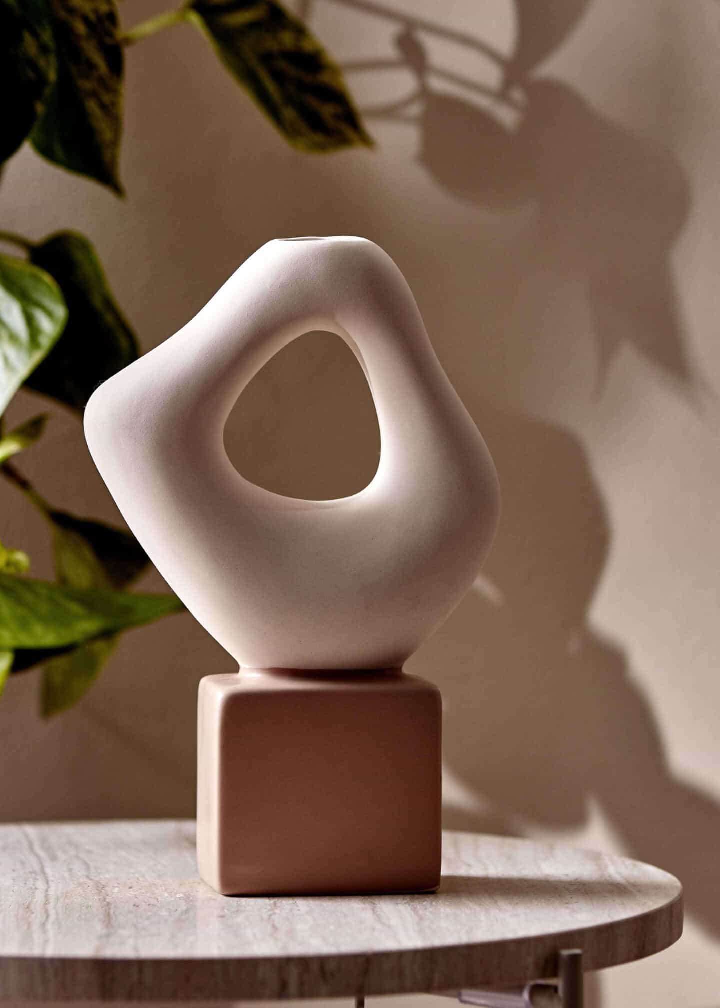 A close-up of a small abstract ornament from Primark on a side table.