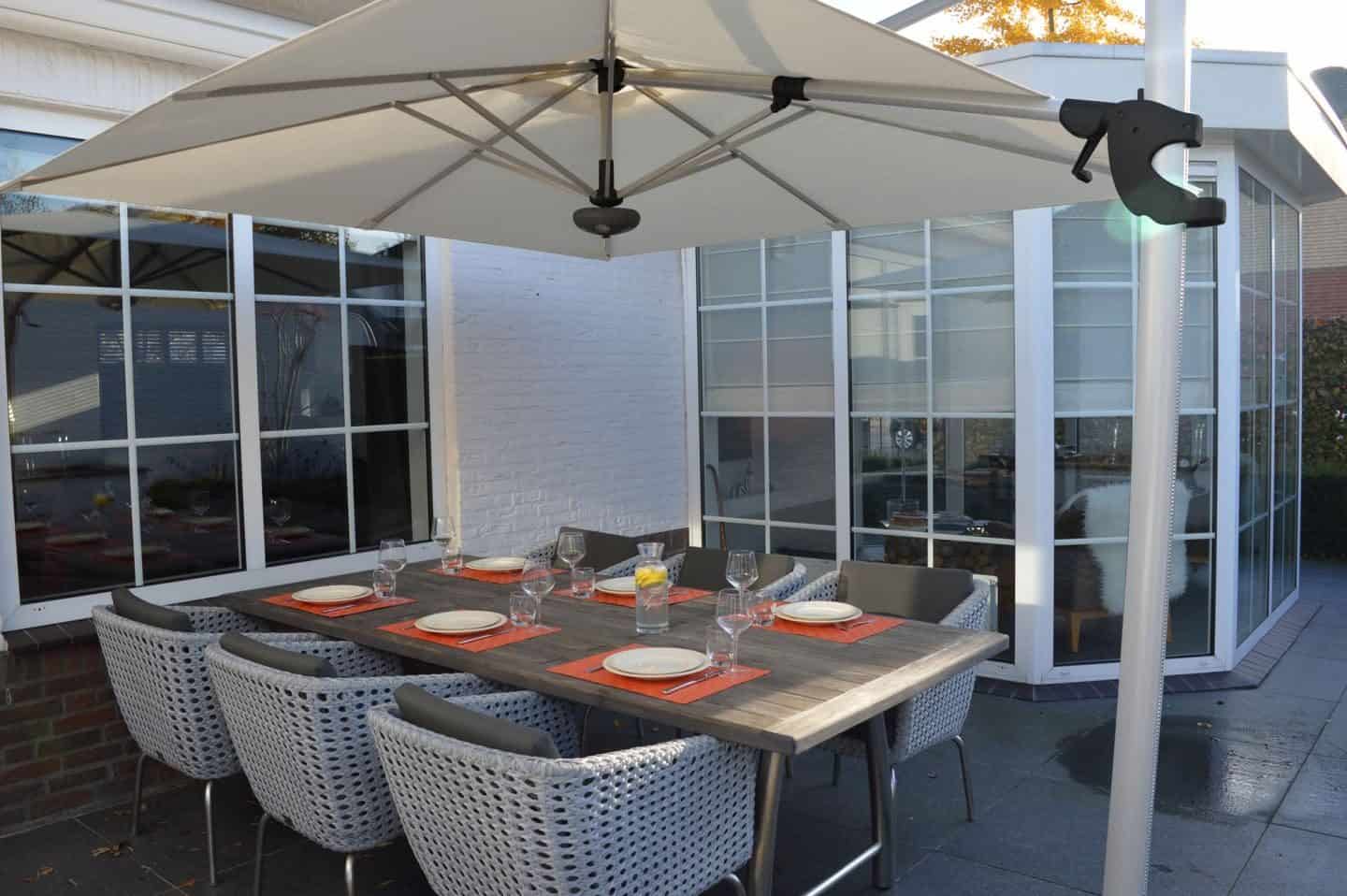 Garden Parasol from Solero Parasols. Large square cantilvered parasol above an outdoor dining set.
