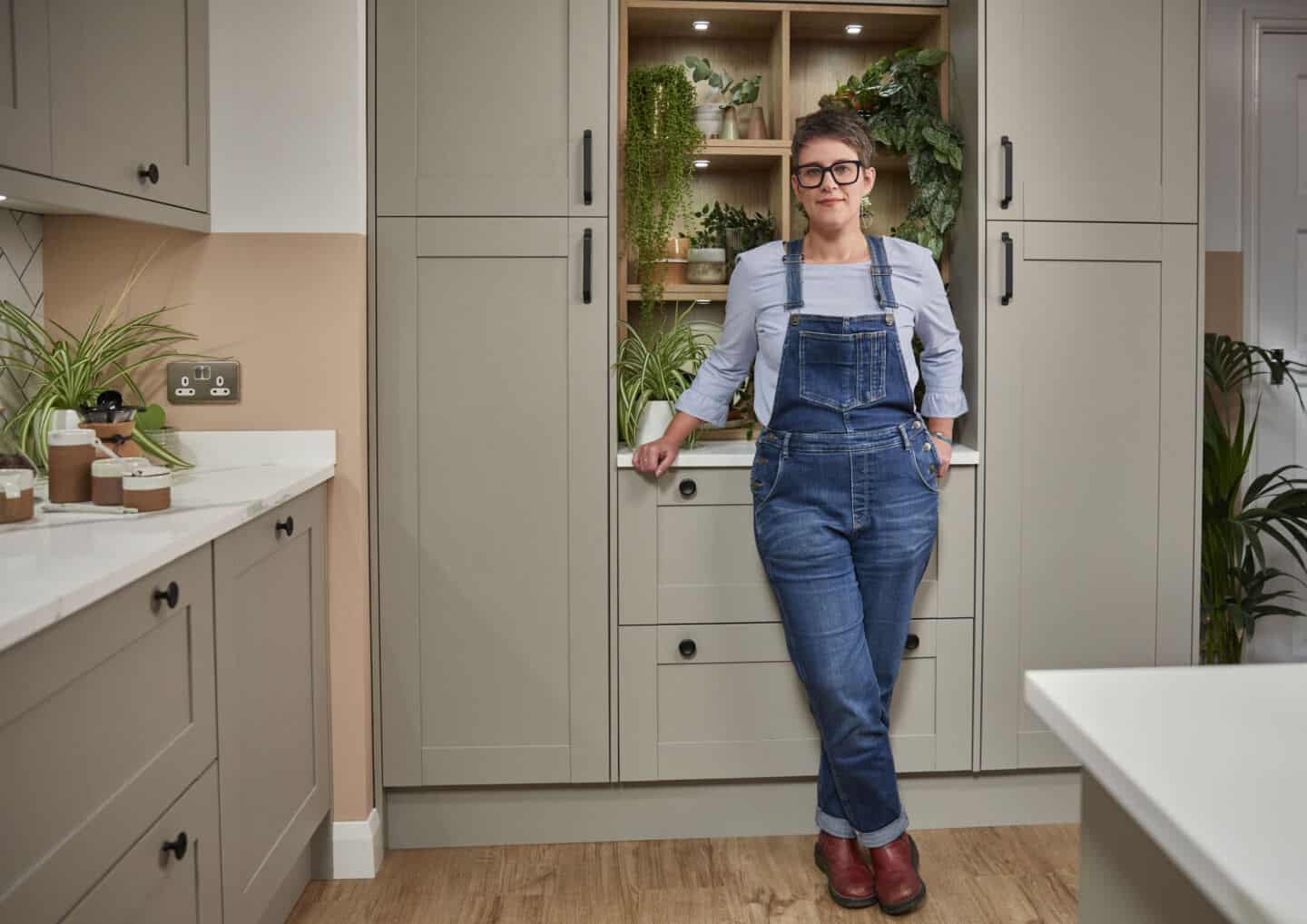 Stacey Sheppard stood in a grey Magnet kitchen