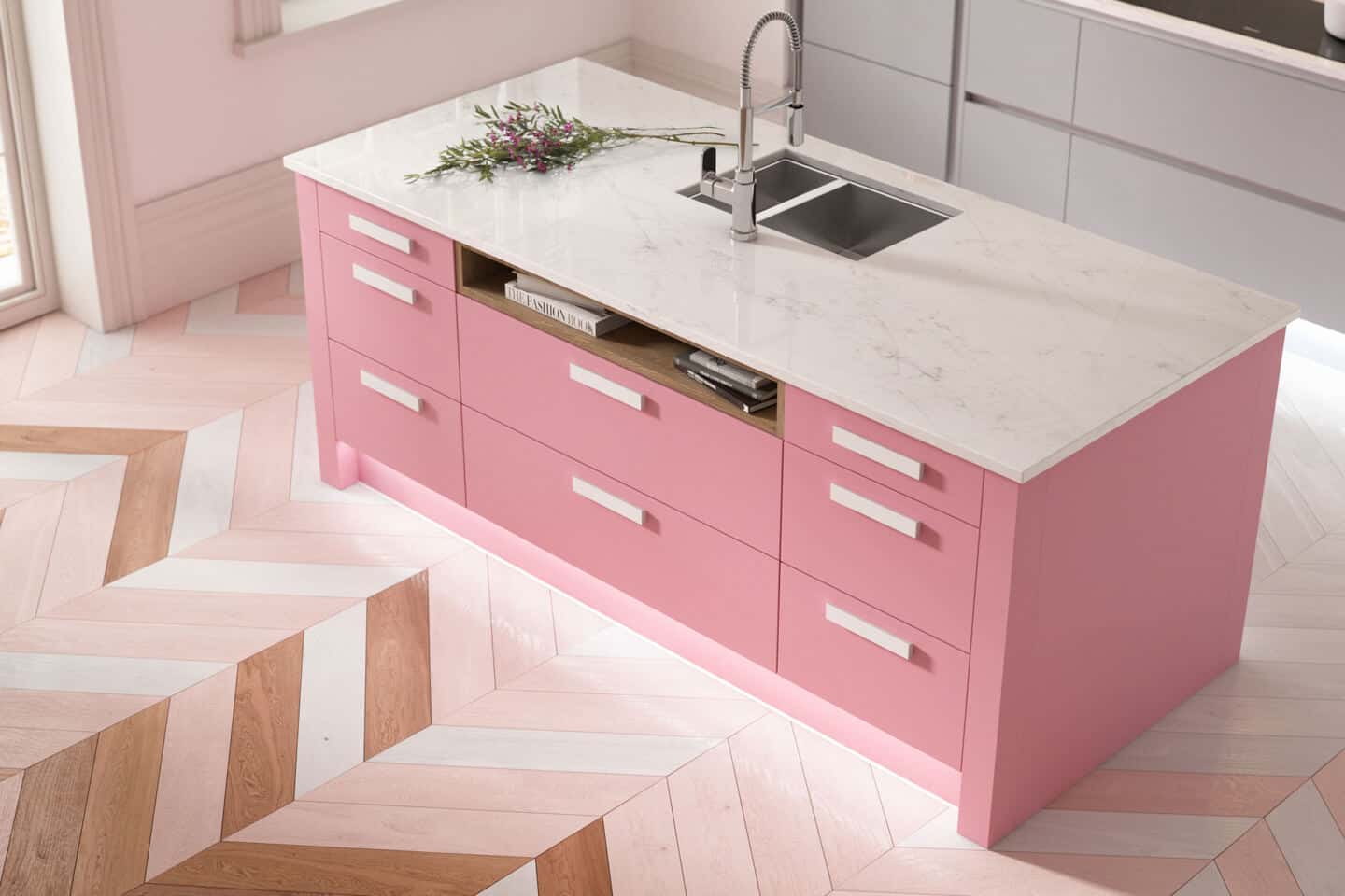 A baby pink kitchen island with marble work top and herringbone floor